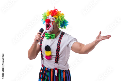 Funny clown with a microphone singing karaoke isolated on white 