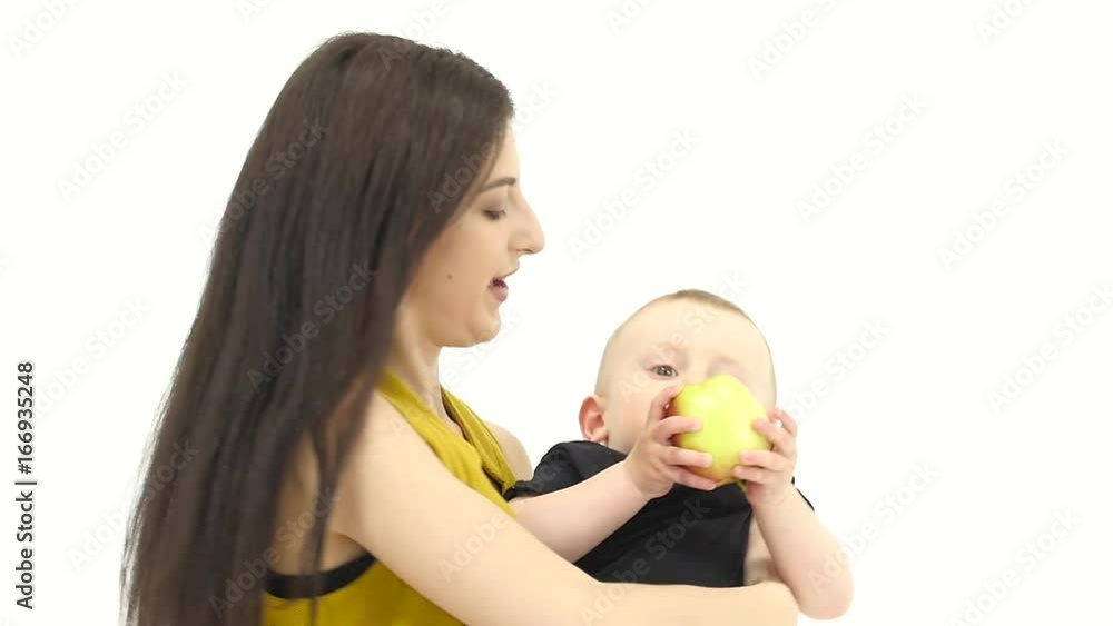 Girl of throws her baby up, he likes it laughs. White background. Slow motion Girl of throws her baby up, he likes it laughs. White background. Slow motion