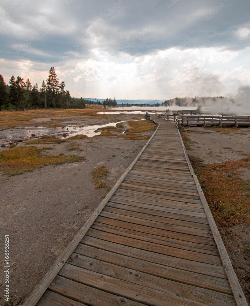 Boardwalk leading to Hot Lake geyser hot spring in the Lower Geyser Basin in Yellowstone National Park in Wyoming United States