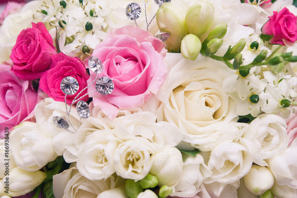 Wedding bouquet made of pink and white roses closeup macro background.