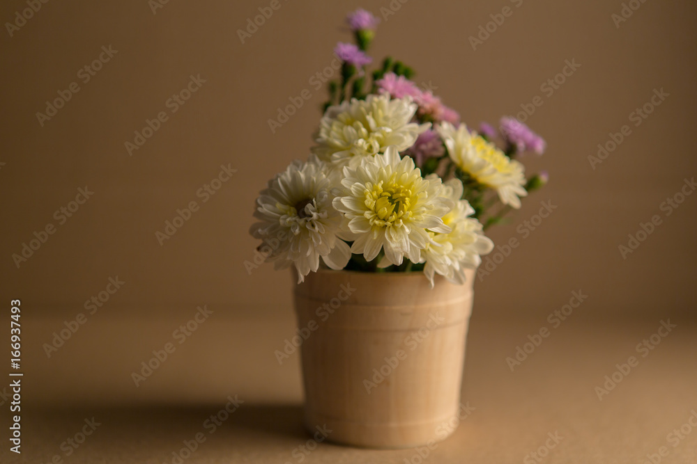 Colorful flowers in the wooden bucket