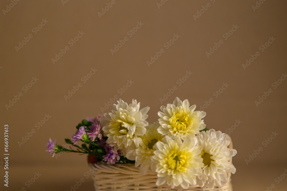 Colorful flowers in the wooden bucket