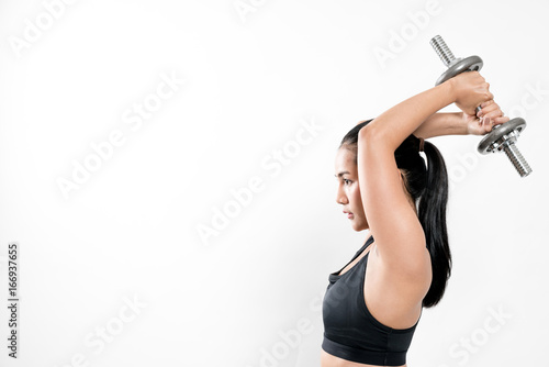sporty girl lifting dumbbells on white background.