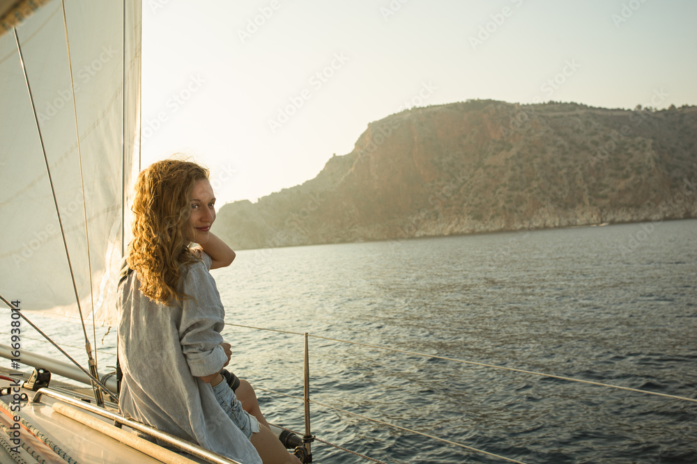 Young blonde woman enjoying sailing