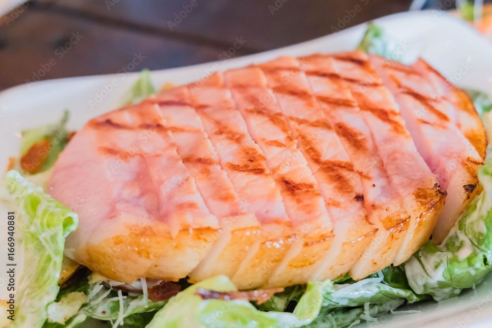 Grilled pork steaks and vegetable salad on the plate . Grilled pork steaks and vegetable salad on the plate .