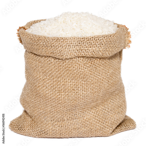 White rice in burlap sack bag isolated on white background