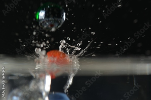 Splash of marbles falling in water