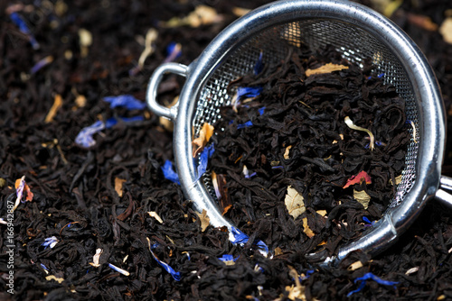 Wallpaper Mural dry black tea with aromatic herbs in a strainer, closeup Torontodigital.ca
