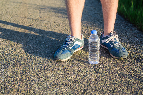 Feet of jogging man photo