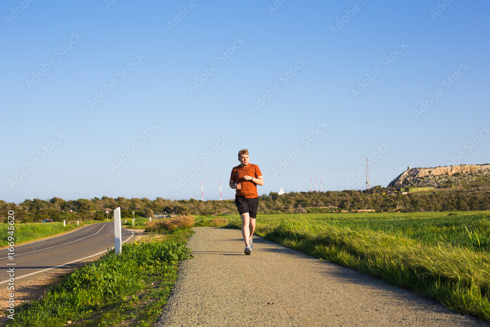 Fototapeta premium Outdoor cross-country running in summer sunshine concept for exercising, fitness and healthy lifestyle