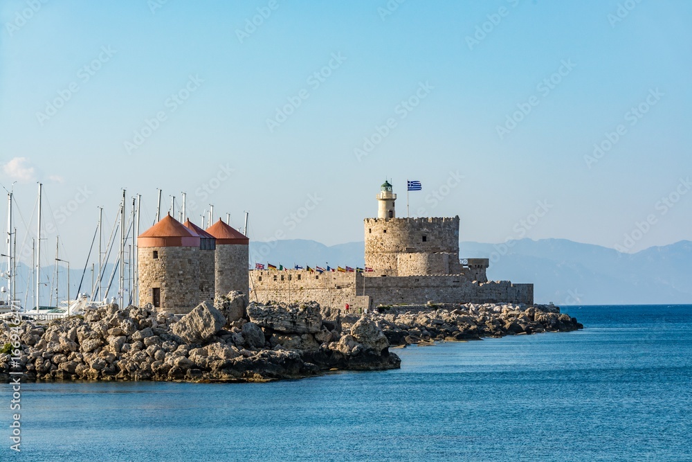 Agios Nikolaos Fort (Fort of Saint Nicholas) and mills, at the entrance to Mandraki harbor, Rhodes island, Greece