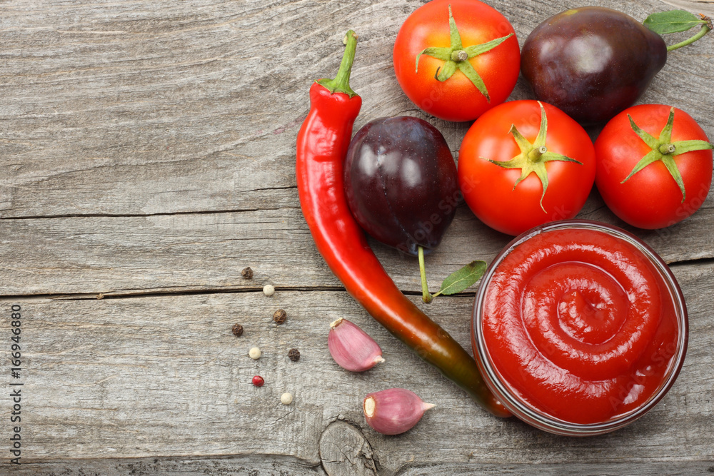 raw plum, tomato, chili pepper and ketchup on wooden table. top view with copy space raw plum, tomato, chili pepper and ketchup on wooden table. top view with copy space
