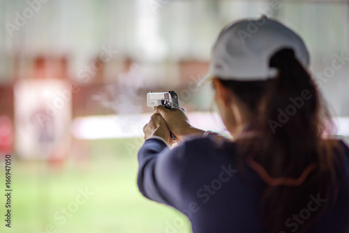 gun holding in hand of woman in practice shooting in martial arts for self defense in an emergency case photo