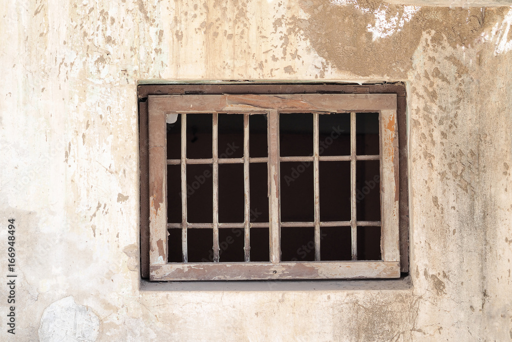 An old wall with a window and a lattice
An old wall with a window and a lattice