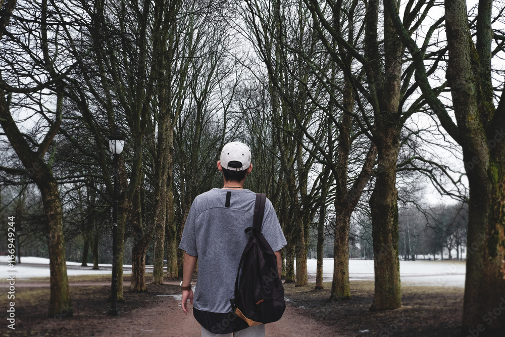 a man walking alone in public parks in winter