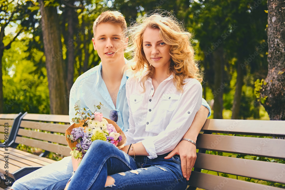 A couple on a dating in a summer park. A couple on a dating in a summer park.