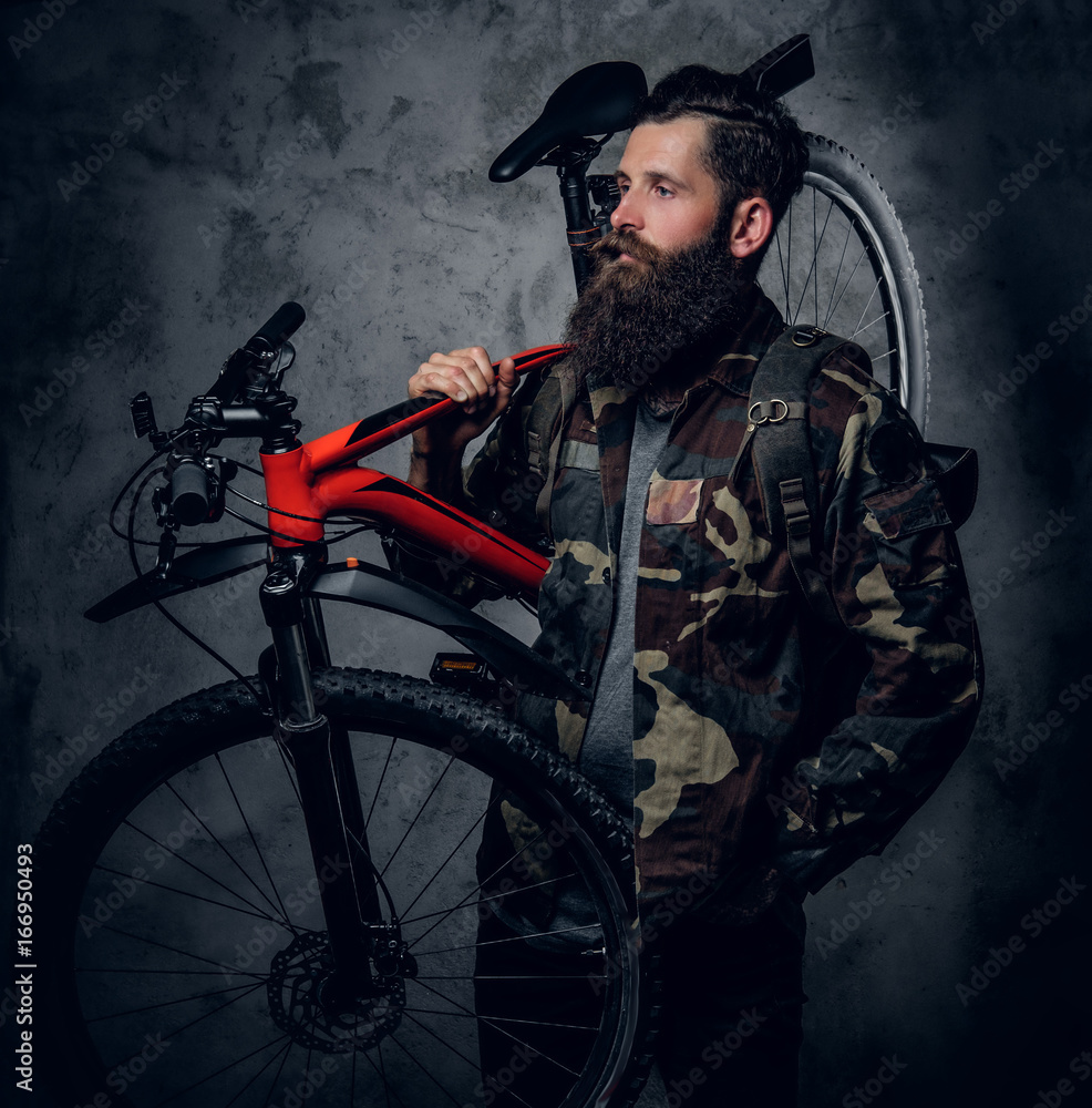 Obraz premium A man holds mountain bicycle.