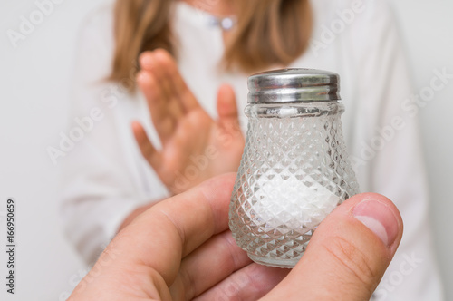 Woman refusing salt using gesture stop photo