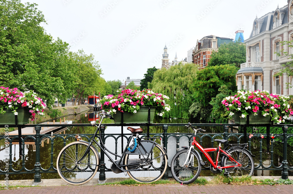 Amsterdam, Holland - bicycles and flowers over a bridge