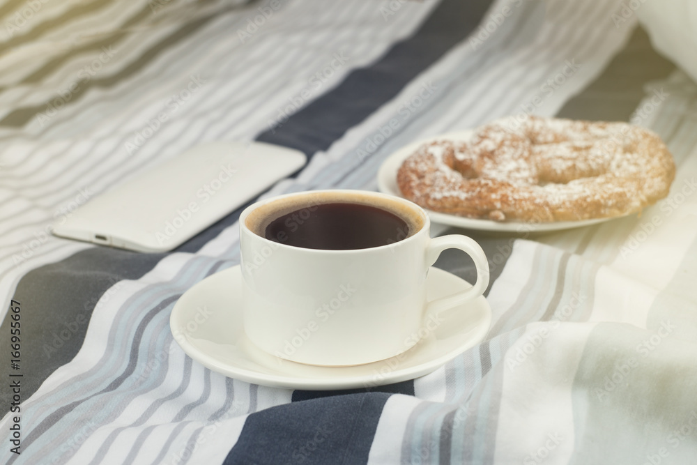 Breakfast in bed with a phone, toned photo Breakfast in bed with a phone, toned photo