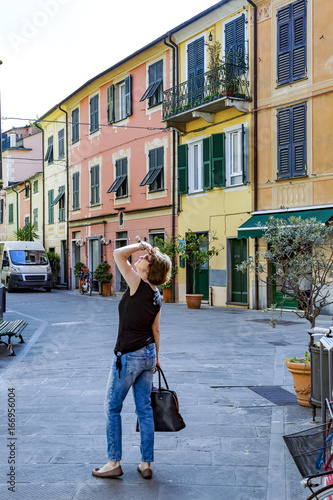 Woman strolling through the city of Levanto on the Ligurian coast