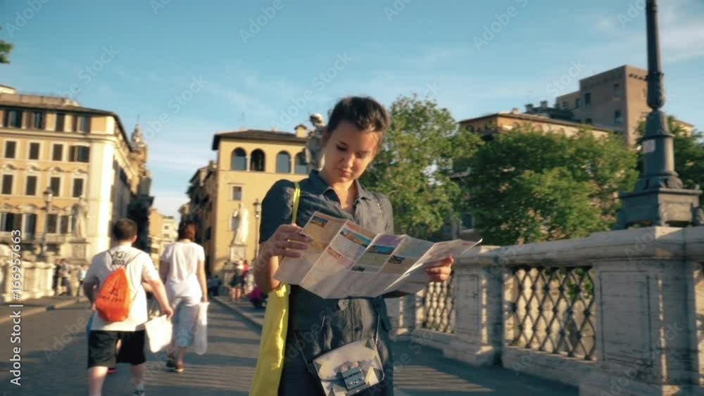 Young Woman Tourist Checks Map on Castel Sant'Angelo Bridge in Rome