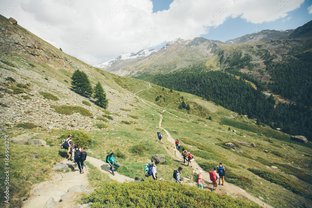 Zermatt, Switzerland - Matterhorn Mountain with white snow and blue sky in Zermatt city in Switzerland. People are hiking to the mountain Zermatt, Switzerland - Matterhorn Mountain with white snow and blue sky in Zermatt city in Switzerland. People are hiking to the mountain