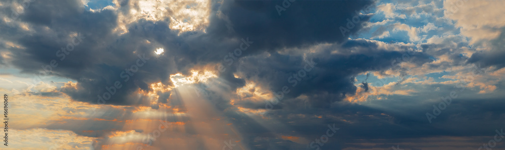 Fototapeta premium dramatic sunset with clouds and sun rays