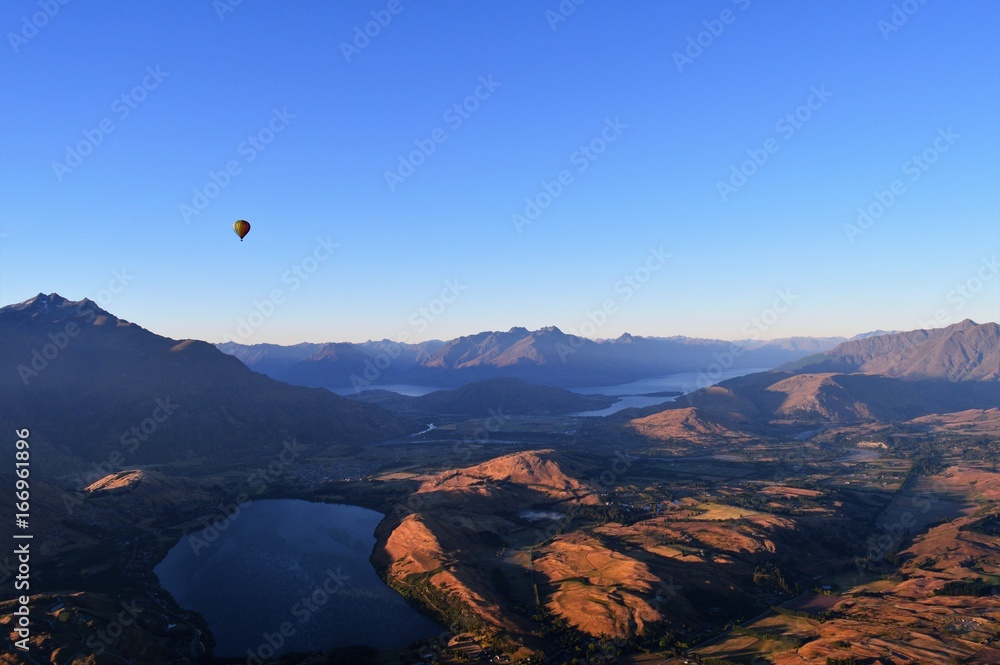 Hot air balloon above lakes and mountains: New Zealand