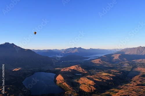 Hot air balloon above lakes and mountains: New Zealand