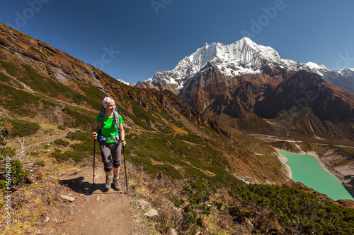 Hiker is climbig to Manaslu base camp in highlands of Himalayas on Manaslu circuit