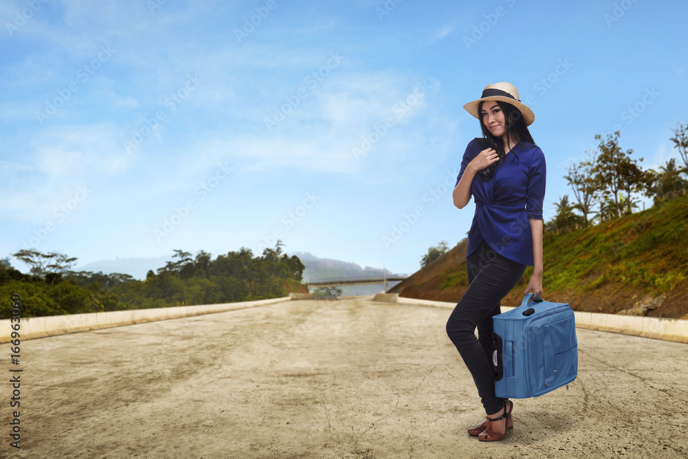 Young asian woman tourist holding suitcase Young asian woman tourist holding suitcase