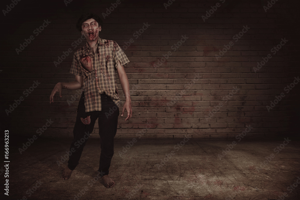Spooky asian zombie man with wounded face walking