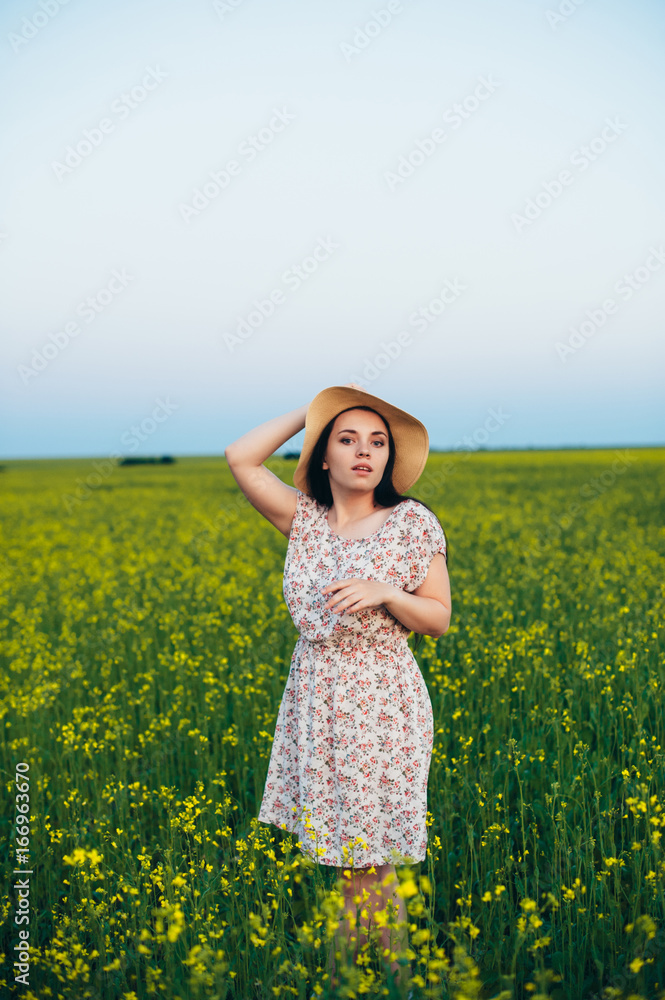 Beautiful young woman at sunset in the field Beautiful young woman at sunset in the field