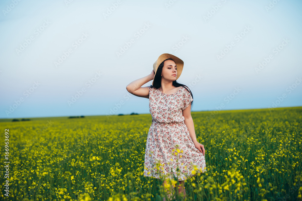 Beautiful young woman at sunset in the field Beautiful young woman at sunset in the field