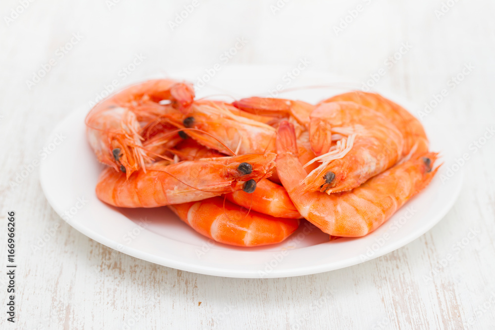 boiled shrimps on white dish on wooden background boiled shrimps on white dish on wooden background