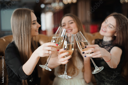 holidays, nightlife, bachelorette party and people concept - smiling women with champagne glasses