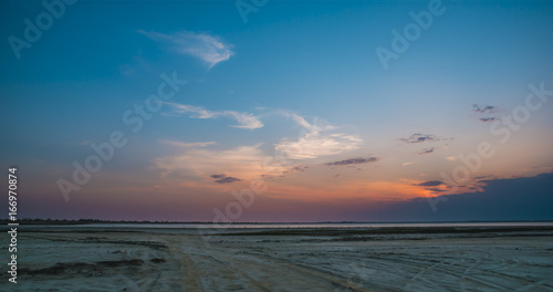 road and lake in sunset time