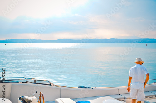 man alone on luxury boat on summer evening