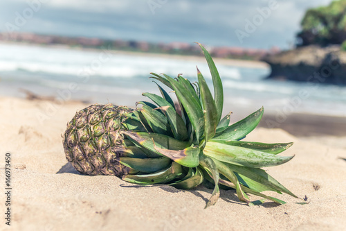 Fresh tropical exotic pineapple fruit on the beach. Parardise island of Bali, Indonesia. photo