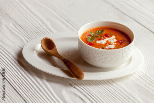 Creamy cheese Tomato Soup on white rustic background