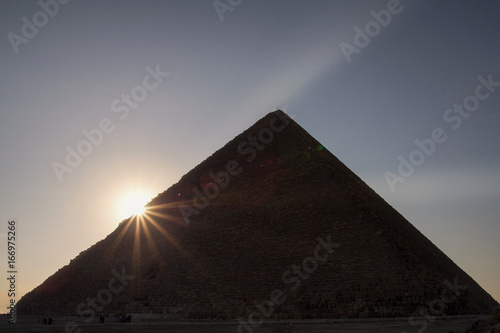 Sun rising behind the Great Pyramid  of Giza.