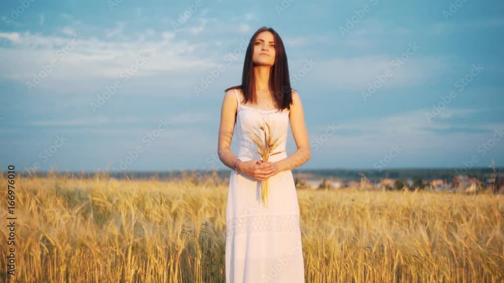beautiful woman with ear wheat in sunlight sunset sensual portrait in summer evening field. atmospheric moment. earth day. stylish boho girl relaxing in meadow. love to land beautiful woman with ear wheat in sunlight sunset sensual portrait in summer evening field. atmospheric moment. earth day. stylish boho girl relaxing in meadow. love to land