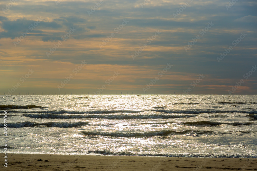 Sea water washes sand on the beach on a sunny day Sea water washes sand on the beach on a sunny day