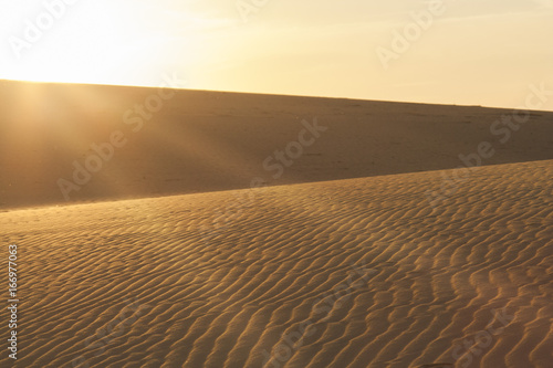 Sun rays over the sand dunes.