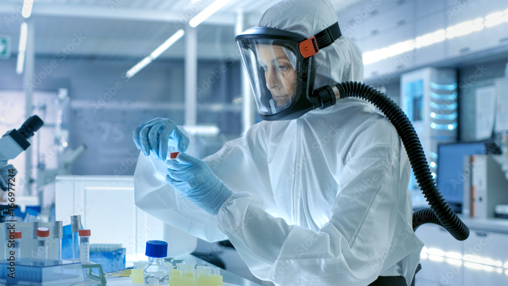 Medical Virology Research Scientist Works in a Hazmat Suit with Mask ...