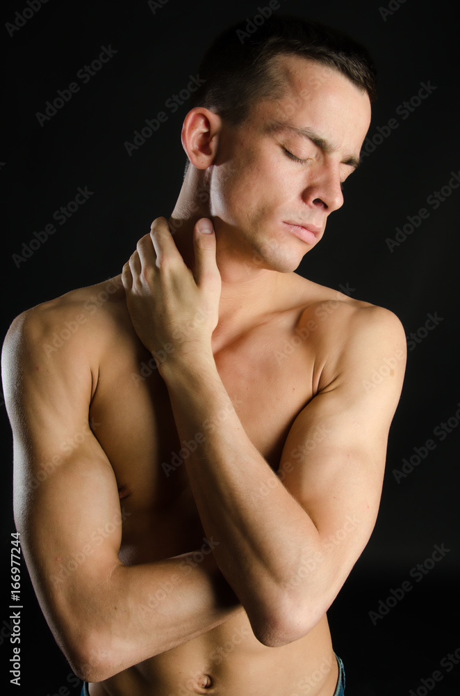 Naklejka premium Young attractive guy. Black background. Studio. 