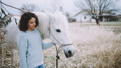 Attractive woman with a horse outdoor