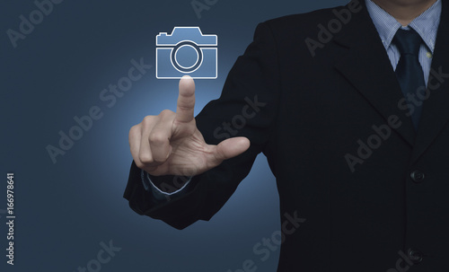 Businessman pressing camera flat icon over gradient blue background, Business camera service concept