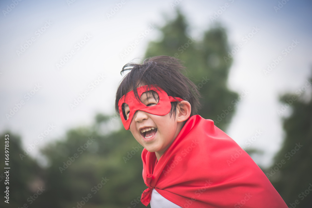 Asian child in in Superhero's costume playing Asian child in in Superhero's costume playing